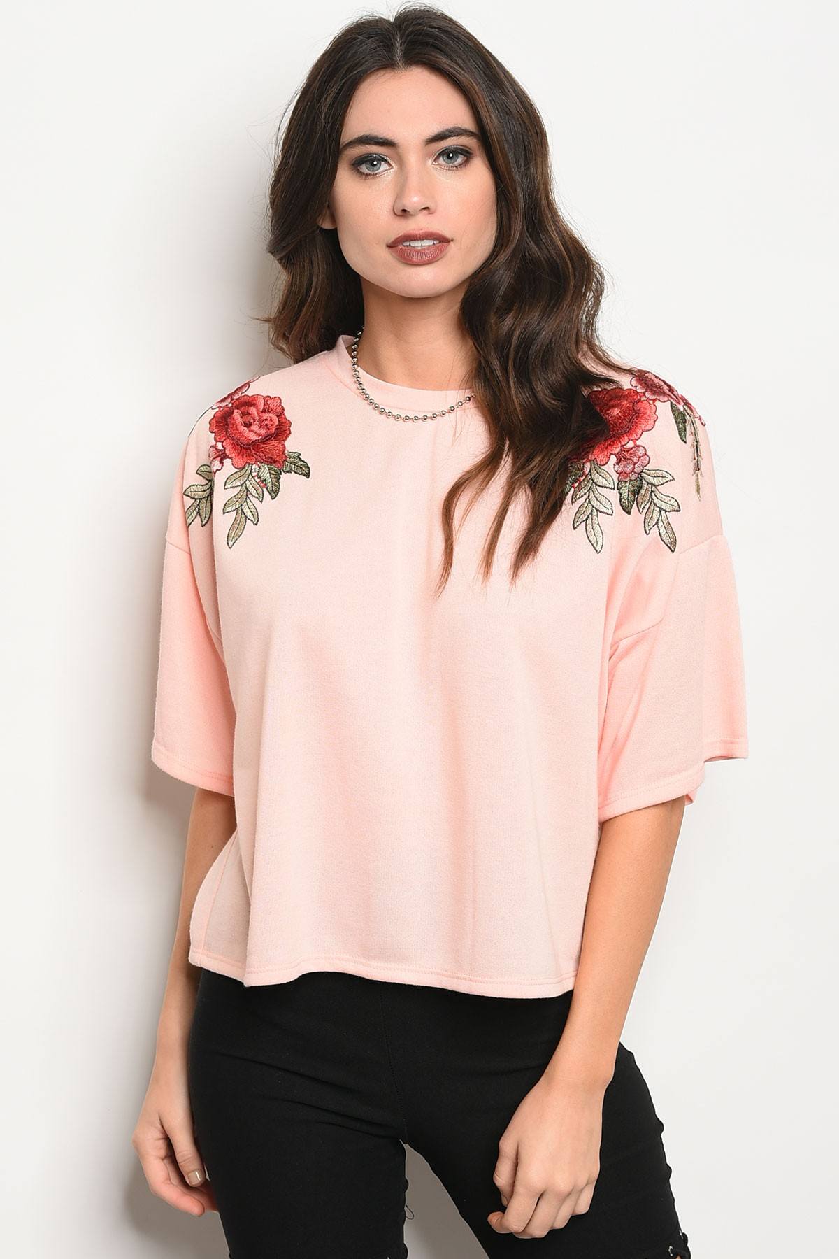 Ladies fashion 3/4 sleeve light weight knit top with a crew neckline and floral patch details