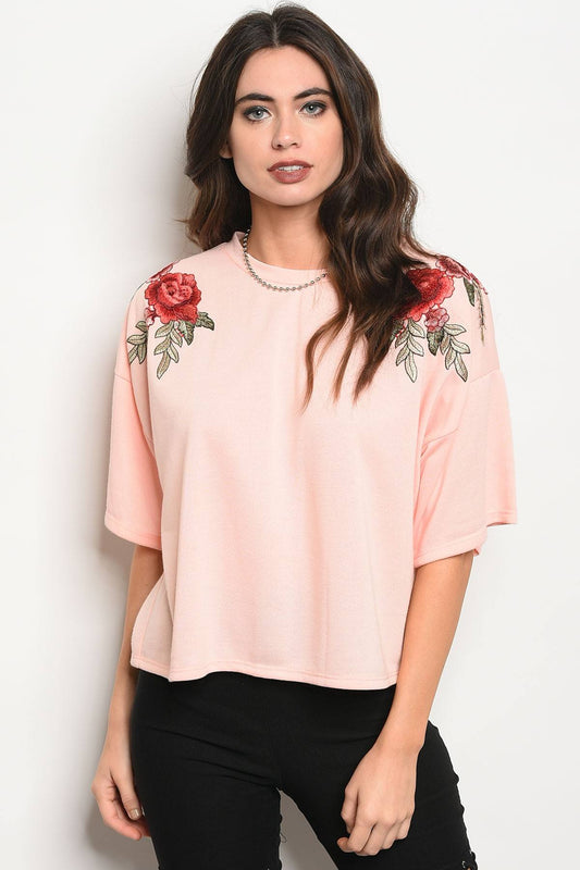 Ladies fashion 3/4 sleeve light weight knit top with a crew neckline and floral patch details