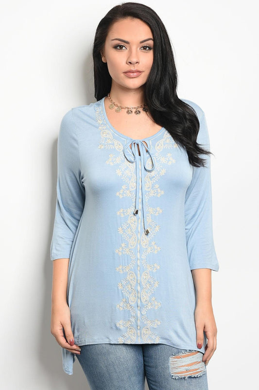 Ladies fashion plus size long sleeve top that features embroidery detail and a rounded neckline