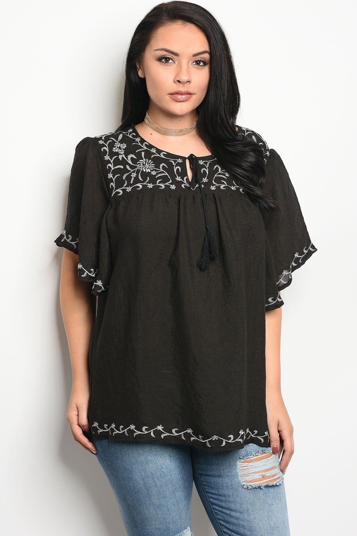 Ladies fashion plus size short sleeve top that features embroidery detail and a rounded neckline