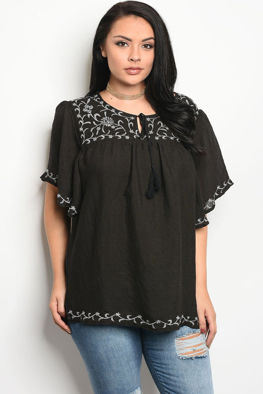 Ladies fashion plus size short sleeve top that features embroidery detail and a rounded neckline