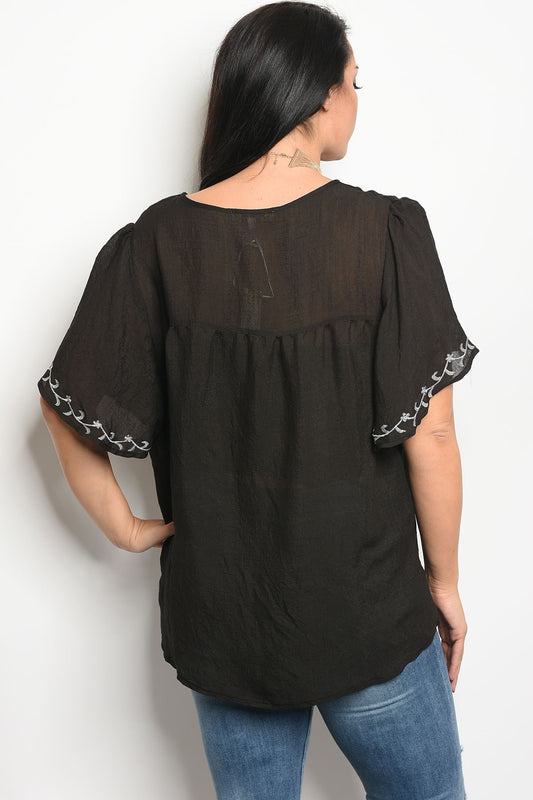 Ladies fashion plus size short sleeve top that features embroidery detail and a rounded neckline